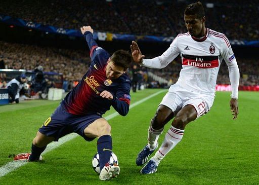 Barcelona&#039;s Lionel Messi (L) vies with AC Milan&#039;s Kevin Constant at Camp Nou stadium in Barcelona on March 12, 2013