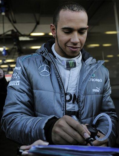 Lewis Hamilton signs autographs during testing on February 20, 2013