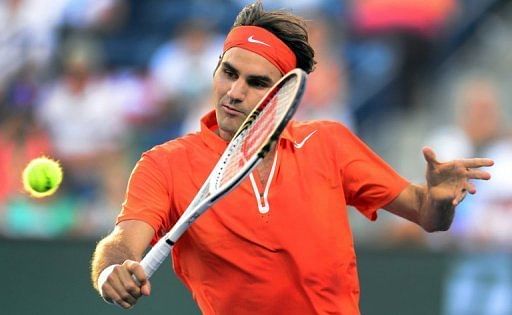 Roger Federer hits a backhand return against Stanislas Wawrinka at the BNP Paribas Open on March 13, 2013