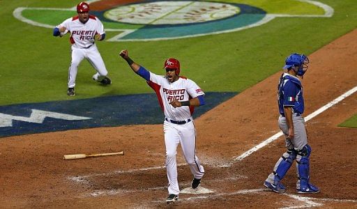 Alex Rios celebrates scoring the game-winning run against Italy on March 13, 2013