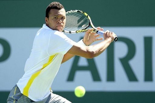 Jo-Wilfried Tsonga of France returns a shot to Milos Raonic 13 in Indian Wells, California, on March 13, 2013