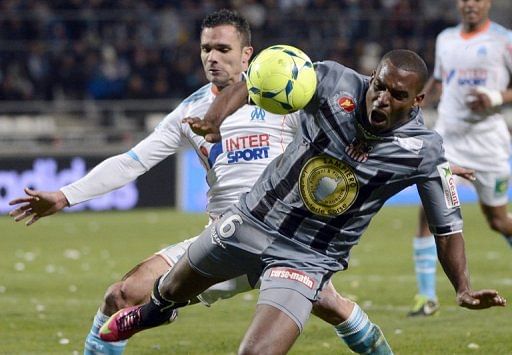 Marseille&#039;s defender Jeremy Morel  (L) vies with Ajaccio&#039;s midfielder Carl Medjani on March 15, 2013