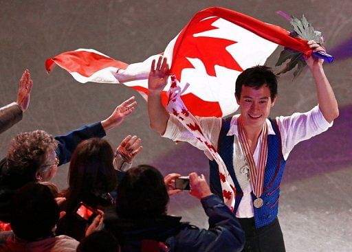 Patrick Chan celebrates his gold title at the World Figure Skating Championships in London, Ontario, on March 15, 2013
