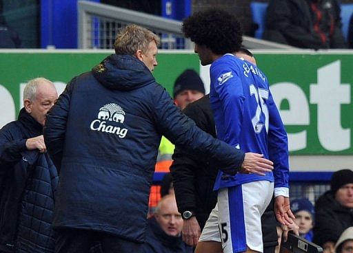 Everton manager David Moyes greets Marouane Fellaini during the match against Wigan Athletic in Liverpool March 9, 2013