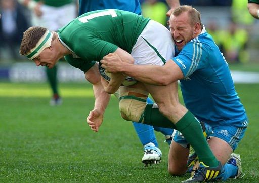 Ireland&#039;s centre Brian O&#039;Driscoll (L) is tackled by Italy&#039;s hooker Leonardo Ghiraldini in Rome on March 16, 2013