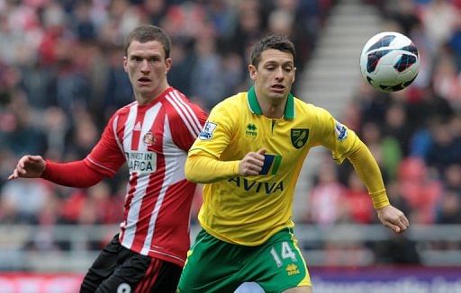 Craig Gardner (left) is tackled by Wes Hoolahan during their Premier League match in Sunderland on March 17, 2013