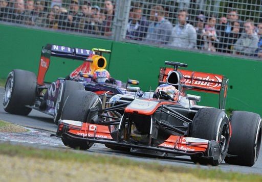 McLaren&#039;s Jenson Button powers ahead of Mark Webber during the Australian Grand Prix on March 17, 2013