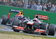 McLaren's Jenson Button powers ahead of Mark Webber during the Australian Grand Prix on March 17, 2013