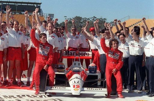 Brazilian Ayrton Senna (L) raises his fist along with his team-mate Alain Prost (R), on November 12, 1988