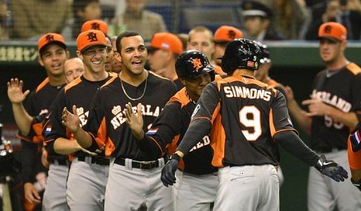 Dutch infielder Andrelton Simmons (no. 9) is congratulated by his teammates during their WBC game on March 12, 2013
