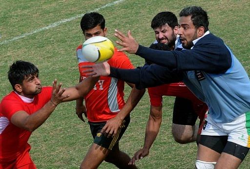 Players battle for the ball in a match between Lahore and the Army on February 24, 2013