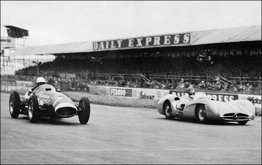 Picture taken in 1954 at Silverstone shows Juan Manuel Fangio (R) in a Mercedes competing with Stirling Moss