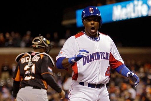 Miguel Tejada of the Dominican Republic celebrates after scoring in the fifth inning on March 18, 2013