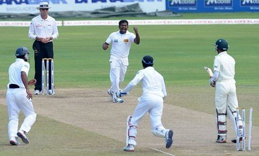Rangana Herath celebrates the dismissal of Nasir Hossain during the fourth day in Colombo on March 19, 2013
