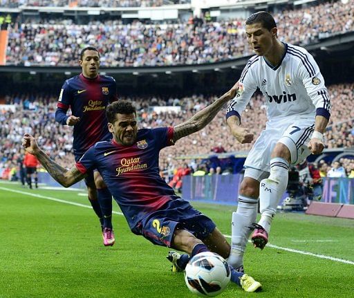 Real Madrid&#039;s Cristiano Ronaldo clashes with Barcelona&#039;s Dani Alves in Madrid on March 2, 2013