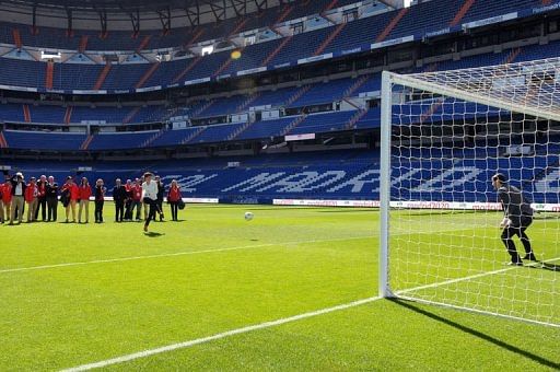 Members of the IOC evaluation team try to score past Real Madrid&#039;s goalkeeper Iker Casillas in Madrid on March 18, 2013