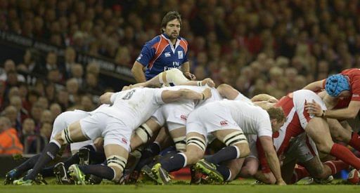 Australian referee Steve Walsh officiates as the scrum collapses on March 16, 2013