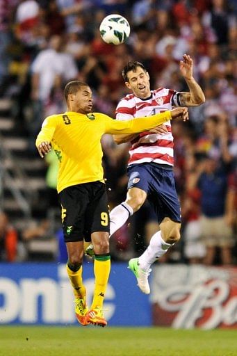 Carlos Bocanegra (R) goes up for the ball with Ryan Johnson of Jamaica on September 11, 2012