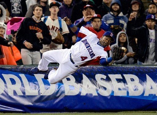 Miguel Tejada of the Dominican Republic dives to make a catch at the World Baseball Classic on March 19, 2013