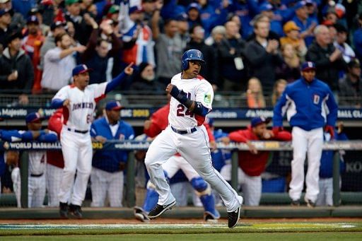 Robinson Cano of the Dominican Republic scores on a two-run RBI double hit by Edwin Encarnacion on March 19, 2013