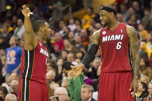 Mario Chalmers (L) and LeBron James discuss a play against the Cleveland Cavaliers on March 20, 2013