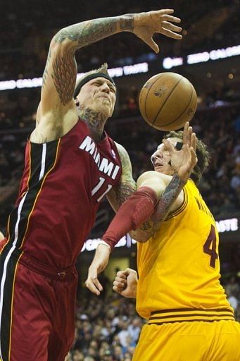 Chris Andersen (L) of the Miami Heat is fouled by Luke Walton on March 20, 2013