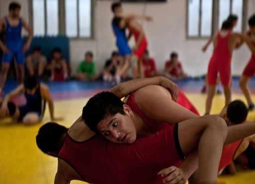 Young Indian wrestlers train in New Delhi on March 4, 2013