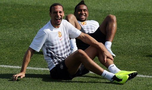 Rio Ferdinand (L) and Anderson Oliveira at a Manchester United training session in Doha on January 22, 2013