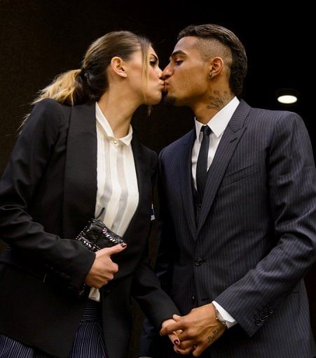 Kevin-Prince Boateng (R) kisses his girlfriend Melissa Satta on March 21, 2013 in Geneva