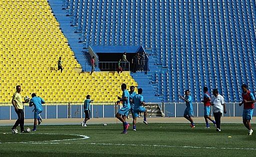 Iraqi footballers train at Baghdad&#039;s Al-Shaab Stadium on April 15, 2011