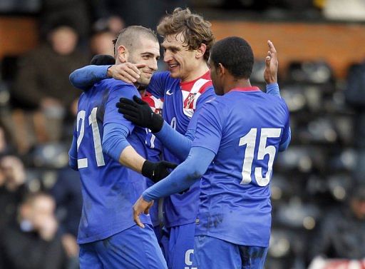 Croatian players celebrate scoring a goal during match against South Korea in London on February 6, 2013
