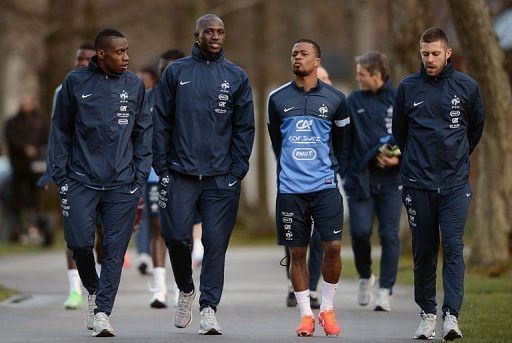 Members of the French national football team arrive for a training session near Paris, on March 18, 2013