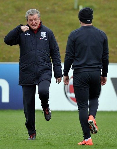 England manager Roy Hodgson (L) and striker Wayne Rooney (R) attend  training in Burton-upon-Trent, March 19, 2013