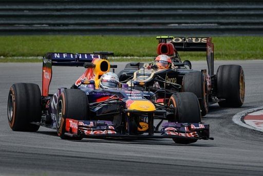 Sebastian Vettel (front) and Romain Grosjean drive in Sepang on March 22, 2013 in practice for the Malaysian Grand Prix