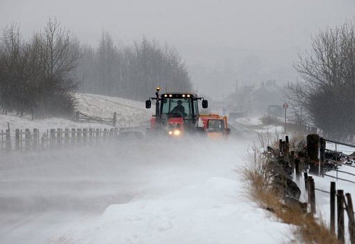 A tractor clears drifting snow from the A6 road near the town of Buxton in north-west England, on March 22, 2013