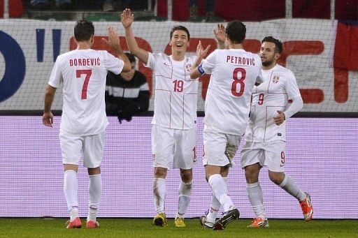 Filip Duricic (centre) celebrates Serbia&#039;s third goal against Chile in St Gallen on November 14, 2012