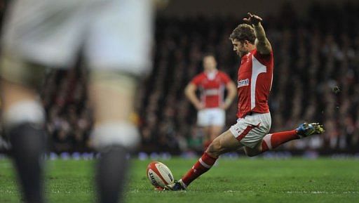 Wales&#039;s full back Leigh Halfpenny kicks a penalty in Cardiff, south Wales on March 16, 2013