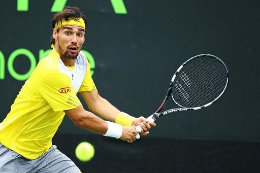 Fabio Fognini of Italy returns a shot against Michael Llodra of France on March 22, 2013