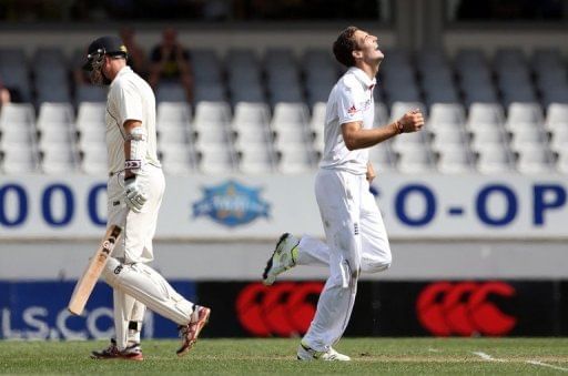 England's Steven Finn (R) celebrates the wicket of New Zealand's Peter Fulton, in Auckland, on March 23, 2013