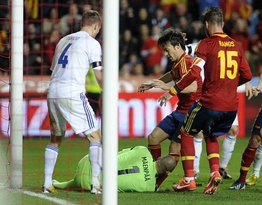 Spain&#039;s David Silva is blocked by Finland goalkeeper Niki Maenpaa in their FIFA 2014 World Cup qualifier March 22, 2013