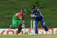 Bangladeshi Tamim Iqbal (L) is run out by Sri Lankan wicketkeeper Kumar Sangakkara in Hambantota, March 23, 2013