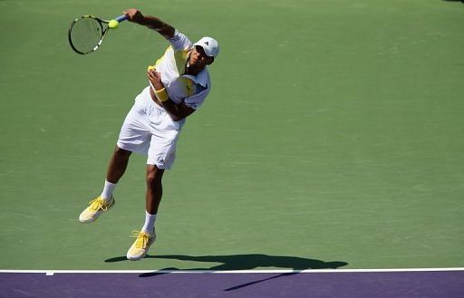 Jo-Wilfried Tsonga of France serves against ViktorTroicki of Serbia on March 23, 2013 in Key Biscayne, Florida