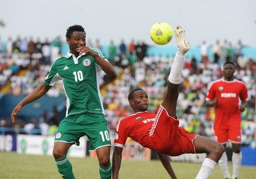 Nigeria&#039;s John Mikel Obi (L) goes for the ball against Kenya&#039;s Mulinge Ndeto, March 23, 2013 in Calabar