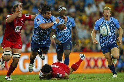 Northern Bulls&#039; Johannes Engelbrecht gets a pass away as he is tackled by Queensland Reds&#039; Ben Tapuai, on March 23, 2013