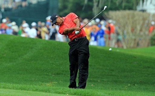 Tiger Woods plays his second shot at the par 4, 1st hole on March 24, 2013 in Orlando, Florida