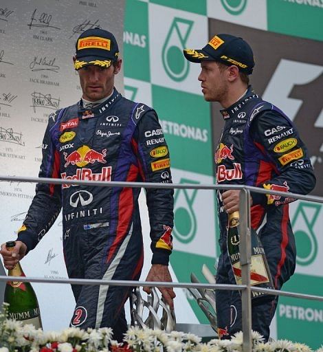 Malaysian Grand Prix winner Sebastian Vettel (R) leaves the podium with his teammate Mark Webber on March 24, 2013