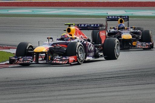 Red Bull driver Mark Webber (L) leads teammate Sebastian Vettel during the Malaysian Grand Prix on March 24, 2013