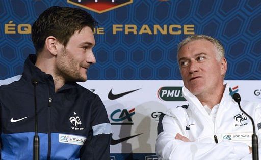 Didier Deschamps (R) speaks with captain and goalkeeper Hugo Lloris during a press conference on March 25, 2013