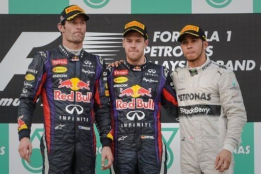 Mark Webber with team-mate Sebastian Vettel (C) and Lewis Hamilton on the podium on March 24, 2013