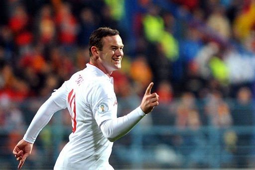 England&#039;s forward Wayne Rooney celebrates after scoring in Podgorica on March 26, 2013